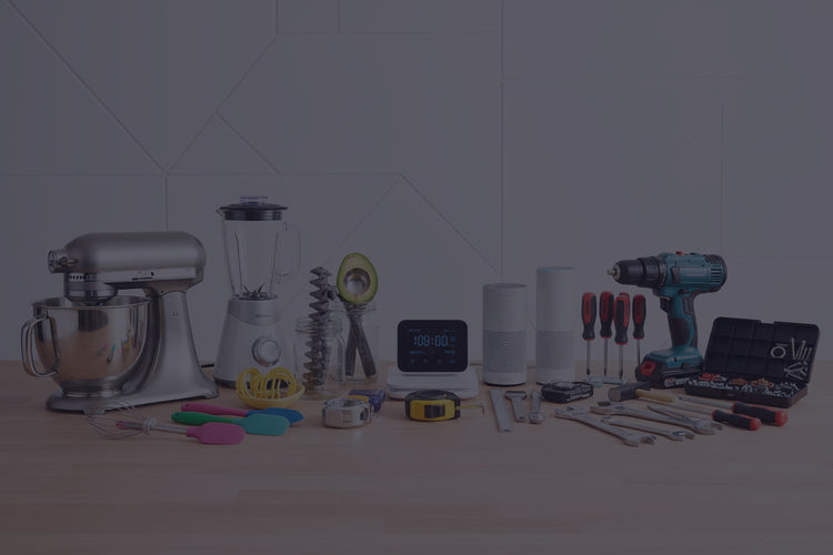 Collection of kitchen appliances and tools on a white surface